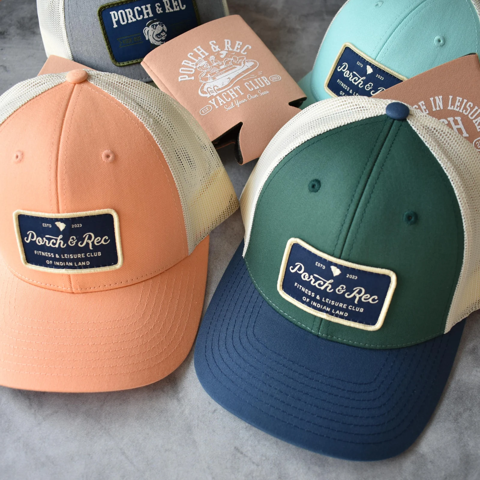 Peach, forest green and seafoam Porch & Rec club hats with vintage embroidered patches